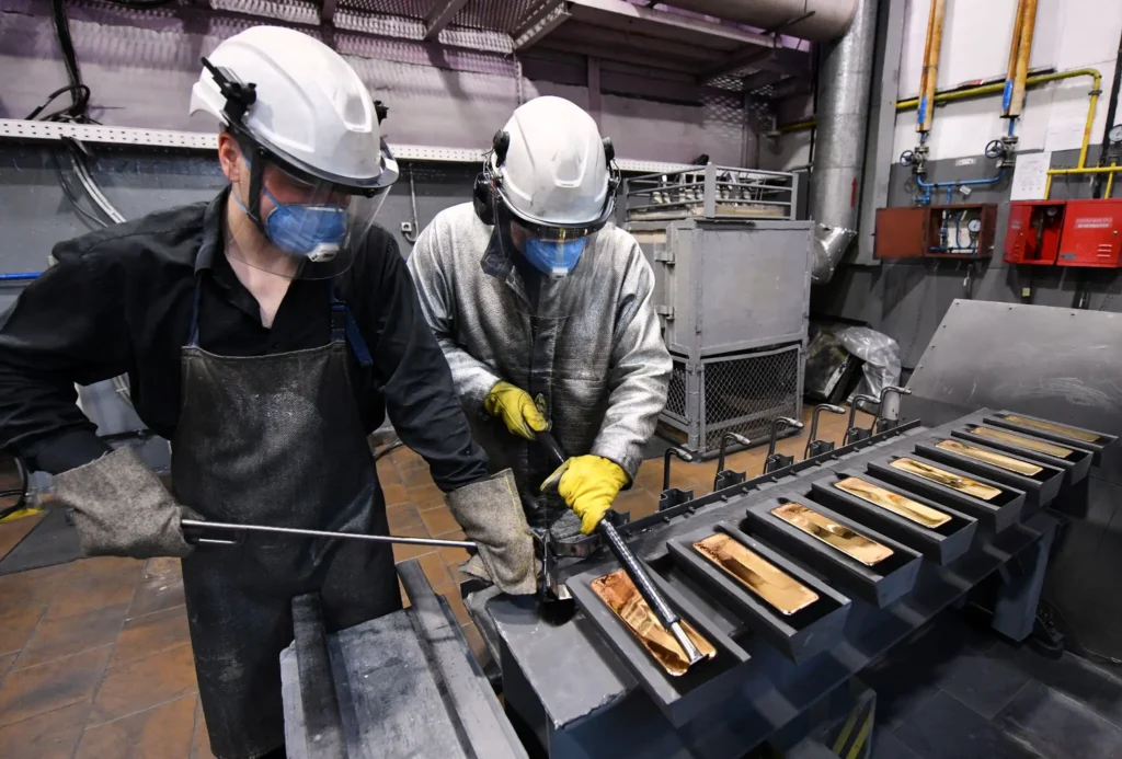 Refinery workers preparing gold doré bars for export and logistics coordination